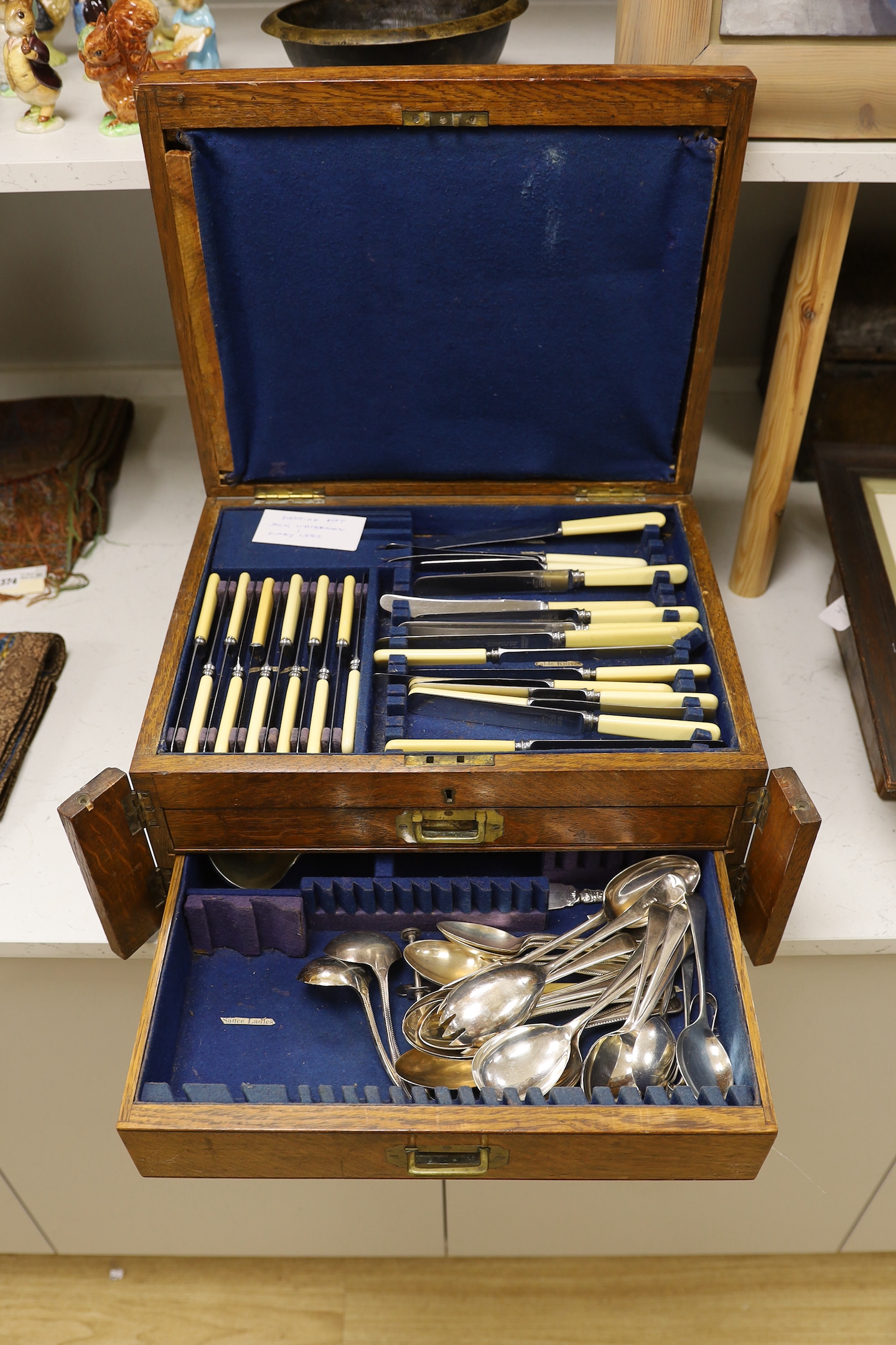 An oak part canteen of beaded Old English pattern flatware